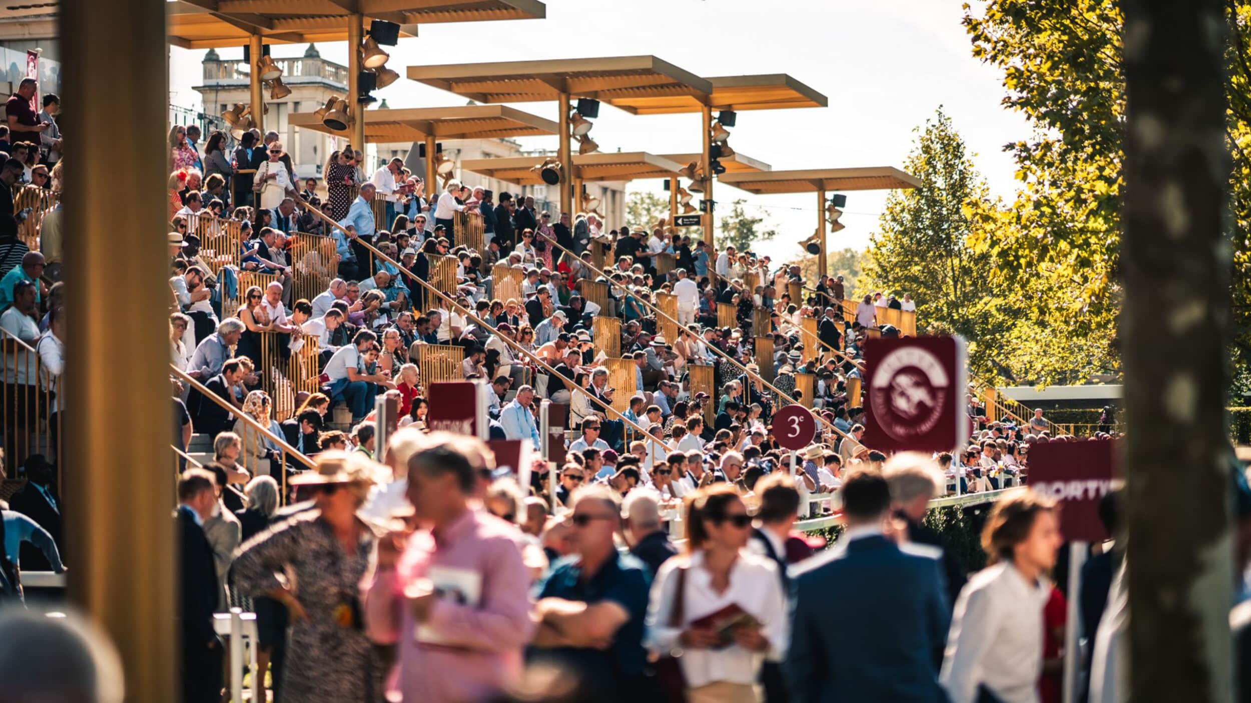 A large crowd of people at stands at an event